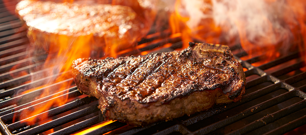 steak on a flaming grill