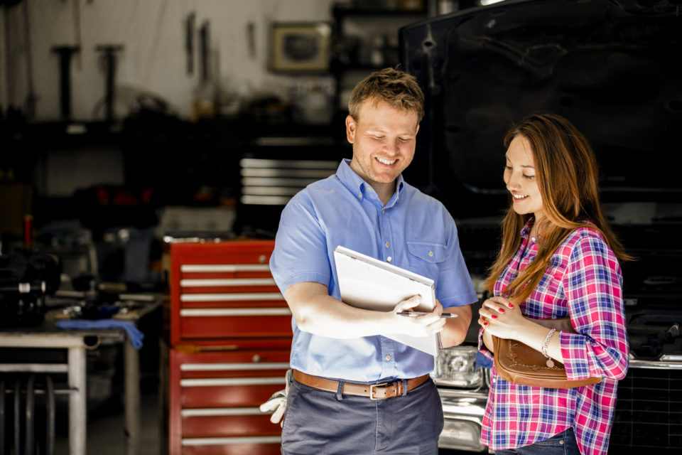 Service technician discussing repairs with a customer