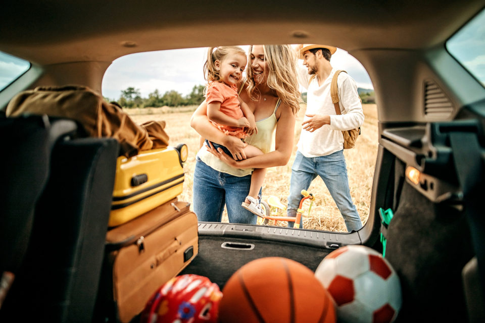 Parents with kid going to picnic with car