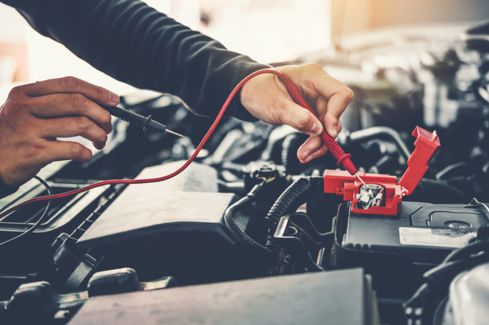 Technician Hands of car mechanic working in auto repair Service and Maintenance car battery